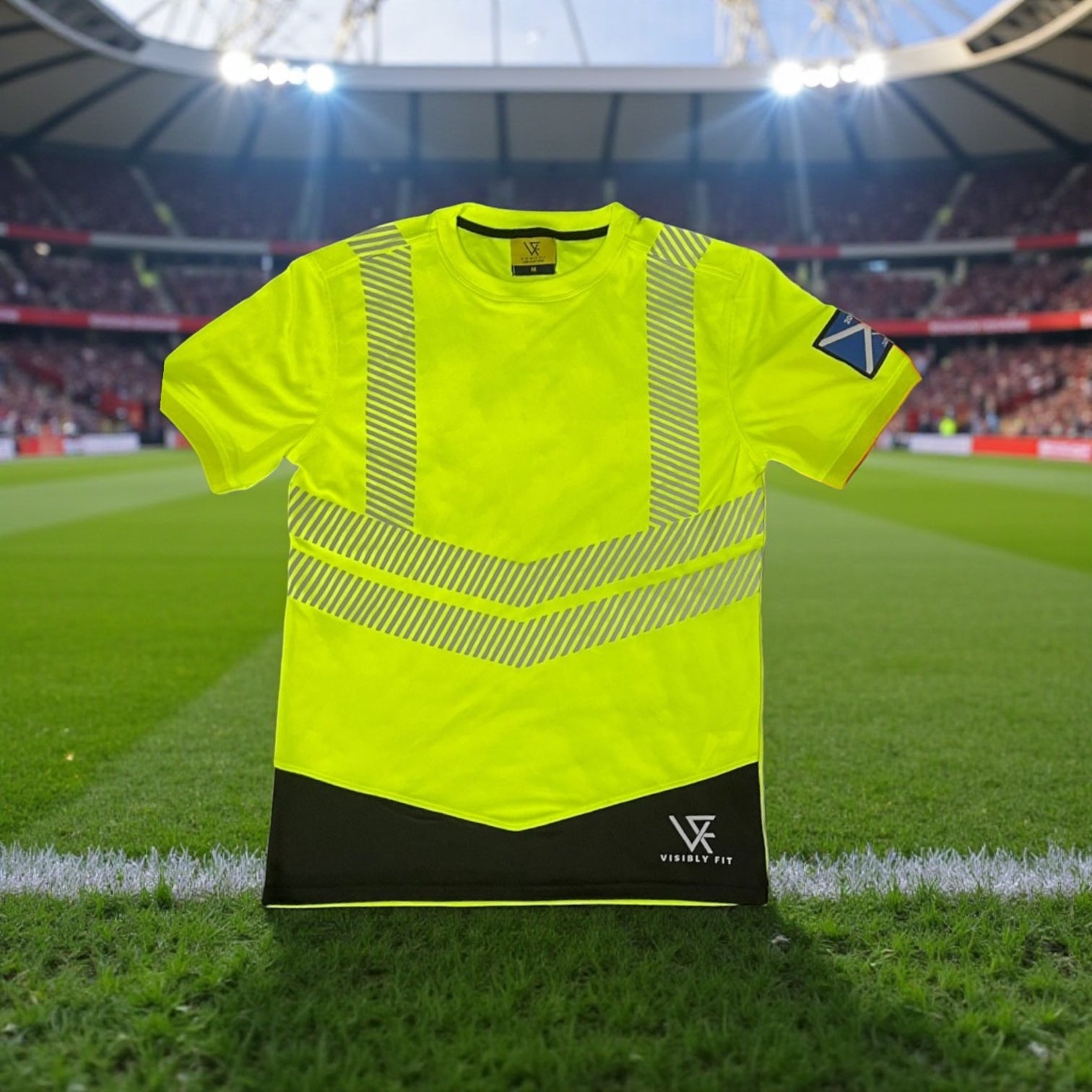 High-visibility safety vest on a sports field with stadium lights in the background